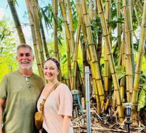 Couple posing in front of bamboo plants