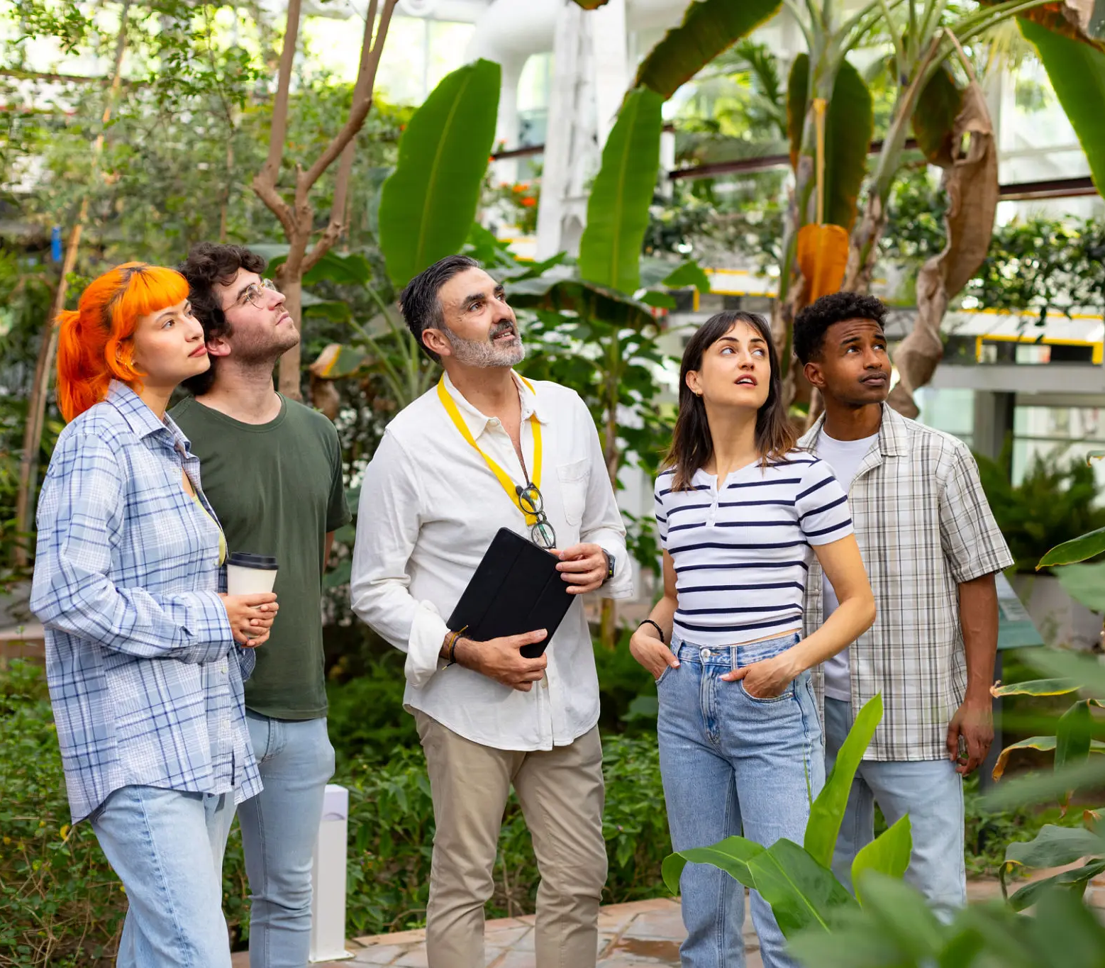 People exploring tropical greenhouse environment